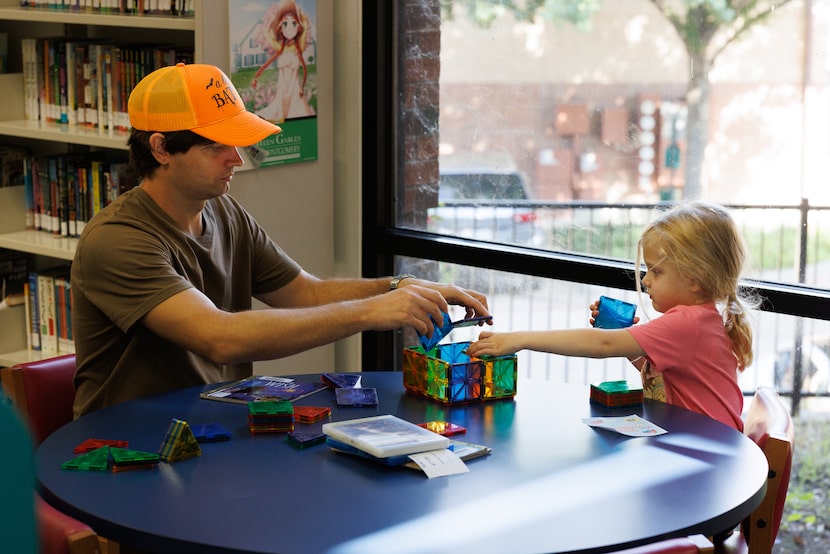 Josh Batty plays with his daughter Lila Batty, 3, at the Skillman Library in Dallas, TX on...