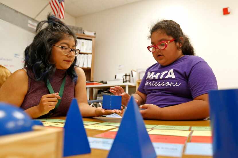 Teacher Veronica Sias (left) helps second-grade student Melanie Arzola during a Lower...