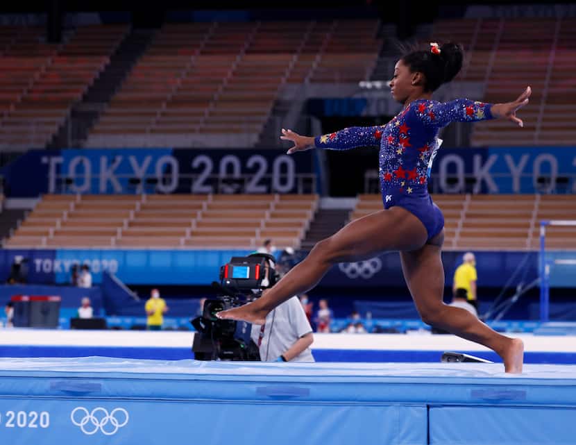 USA’s Simone Biles takes a few steps upon landing while competing on the balance beam in a...