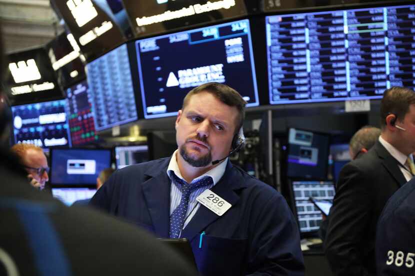  Traders work on the floor of the New York Stock Exchange on March 25.