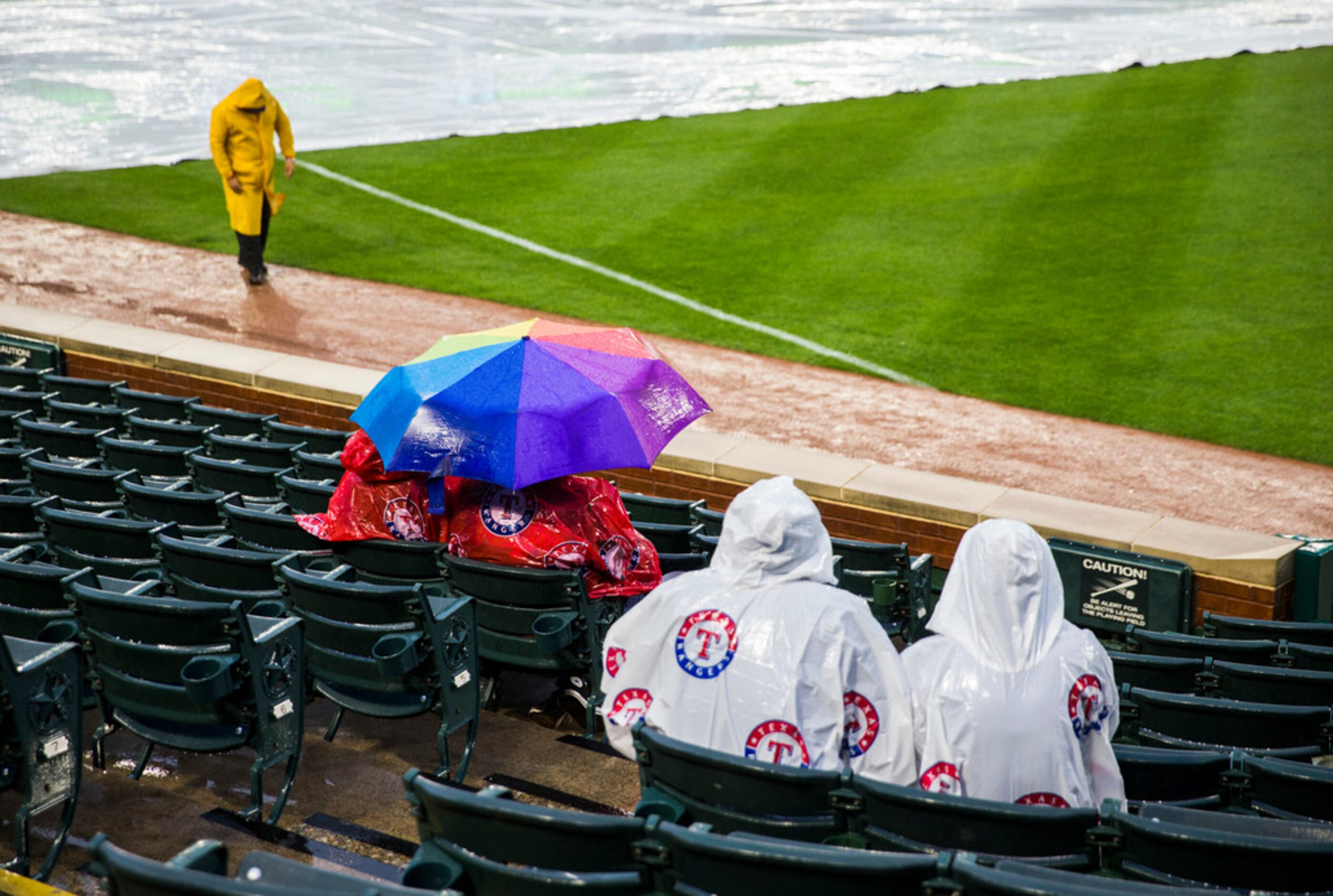 Texas Rangers fans wait in the rain before an MLB game between the Texas Rangers and the...