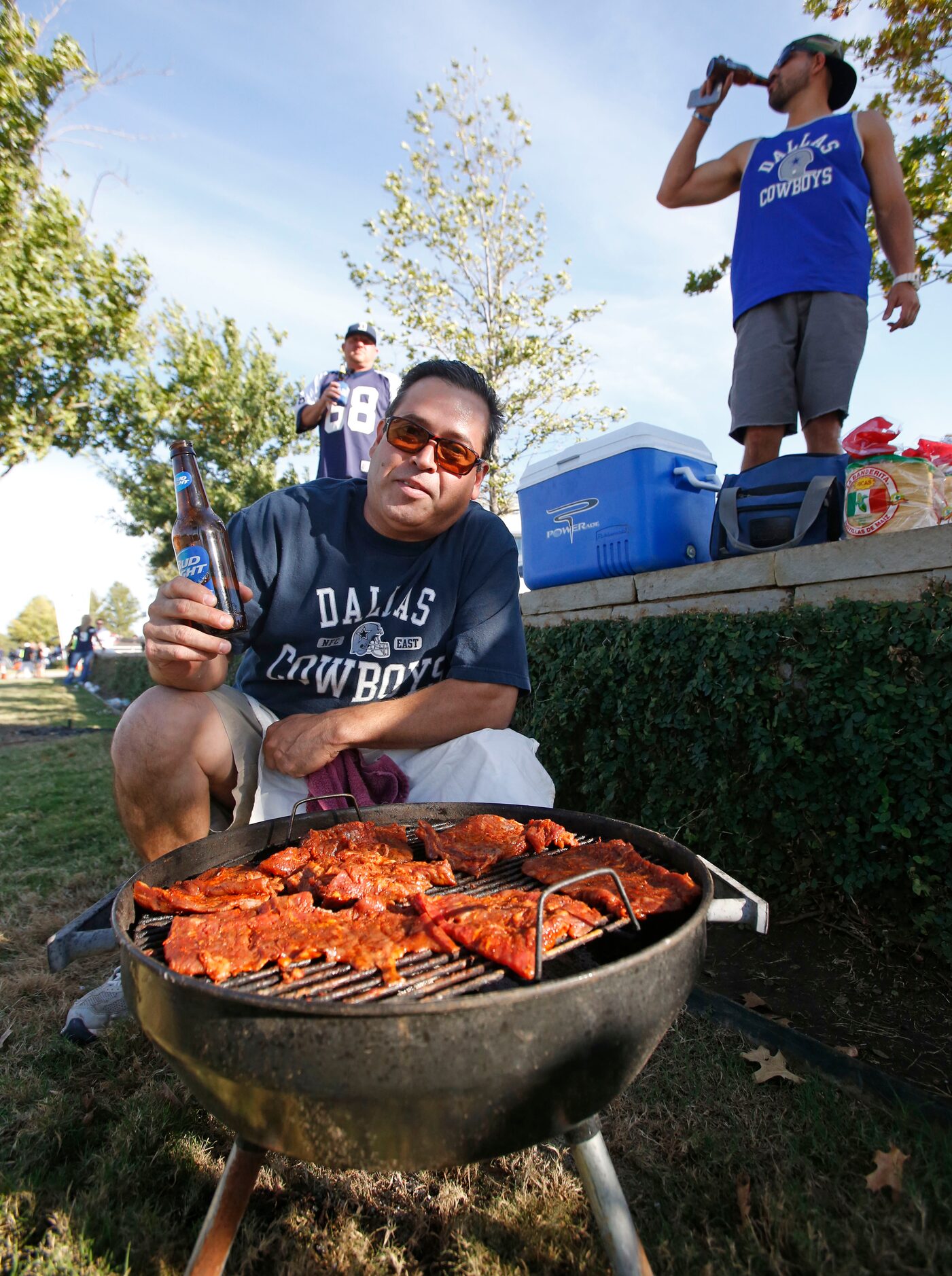 Rafael Del Prado fires up the grill as he tailgates with friends before the Washington...