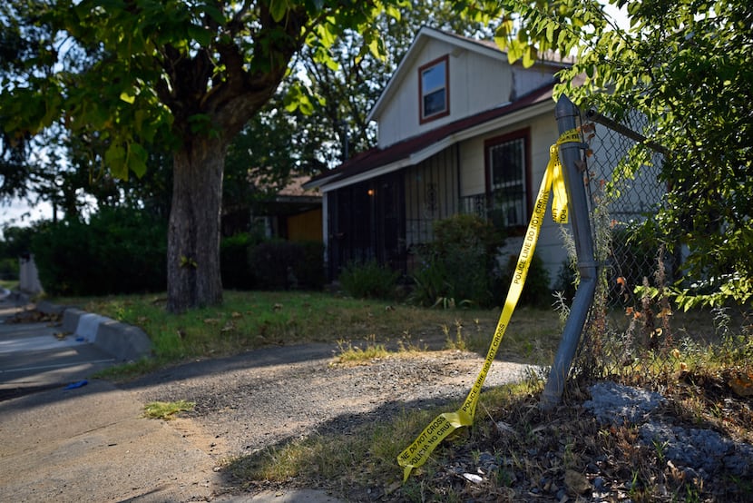 Crime scene tape remains outside of a house on the 4200 block of Jamaica Street in Dallas,...