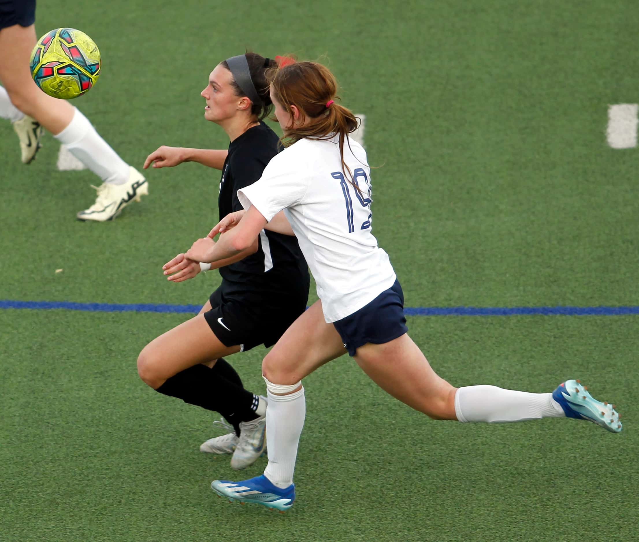 Flower Mound Marcus midfielder Emma Fioretti (8), left center, focuses on the ball as she is...