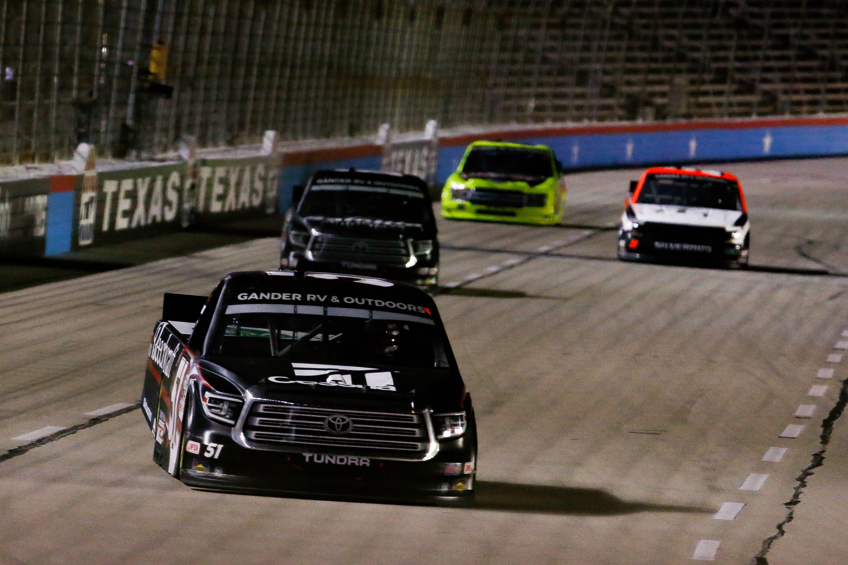 Driver Kyle Busch (No. 51) wins after crossing the finish line during the Vankor 350 NASCAR...