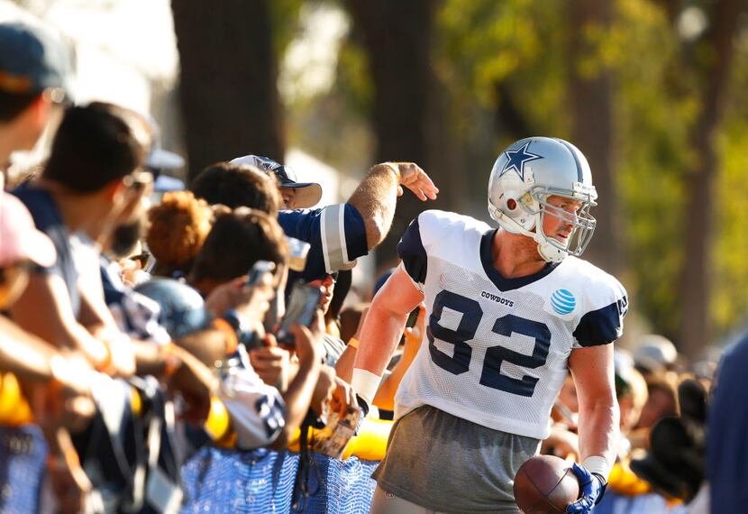 Dallas Cowboys tight end Jason Witten (82) is cheered as he runs up against the fence line...