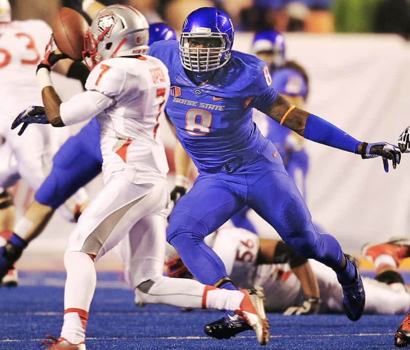 Boise State defensive end Demarcus Lawrence (8) eyes New Mexico running back Teriyon Gipson...