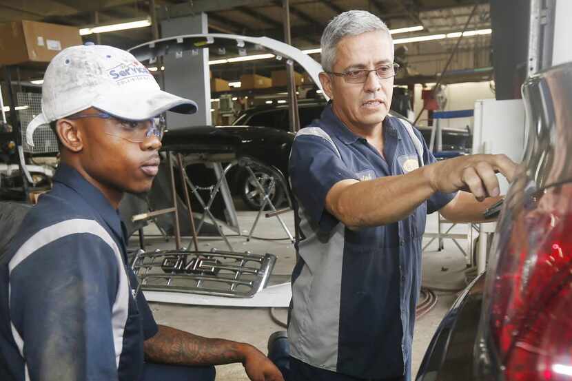 Supervisor Ralph Gonzales  (right) inspects the work of apprentice Kenneth Buford at the...