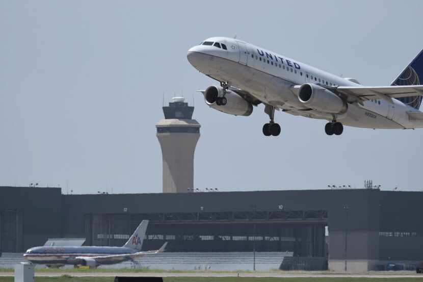 A United Airlines flight takes off at Dallas-Fort Worth Airport on July 1, 2014.  An...