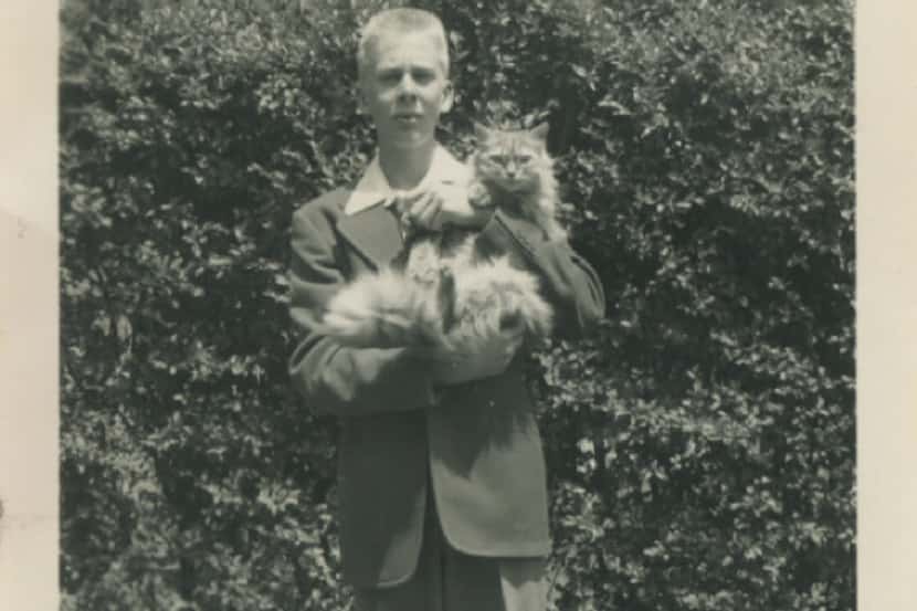 A 13-year-old Boone Pickens holds his cat, Sandy, in 1941, the year after he started his...