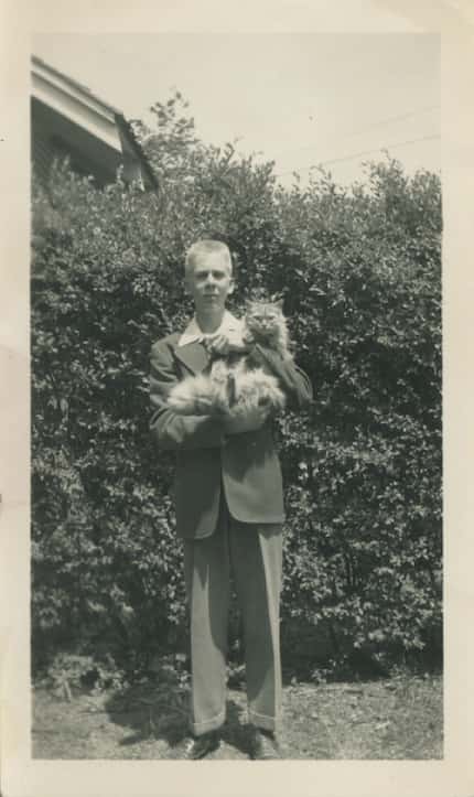 A 13-year-old Boone Pickens holds his cat, Sandy, in 1941, the year after he started his...