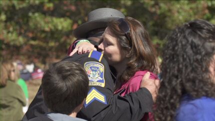 Nicole Hockley, mother of Sandy Hook victim Dylan, hugs first responder Sgt. William Cario...