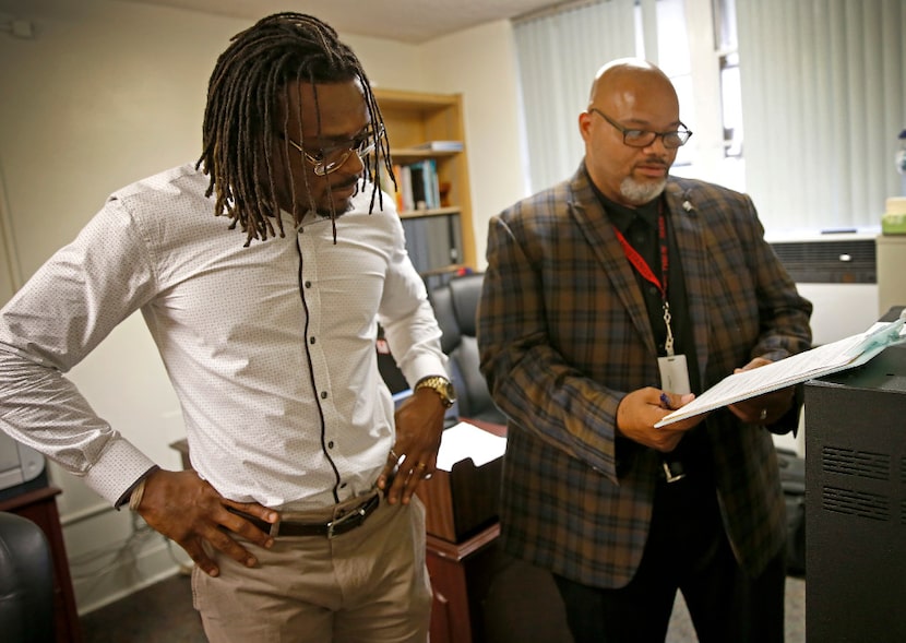 Principal Derrick Ross (right) helped Dallas Cowboys cornerback Brandon Carr do the morning...