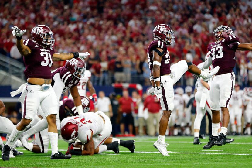 Texas A&M Aggies defenders from left Shaan Washington (33),  Armani Watts (23) and Claude...