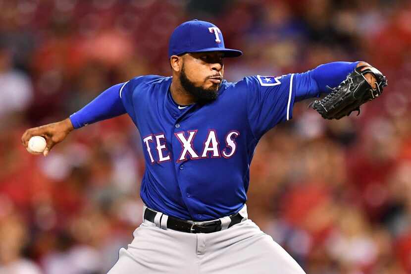 CINCINNATI, OH - AUGUST 23:  Jeremy Jeffress #23 of the Texas Rangers pitches in the seventh...