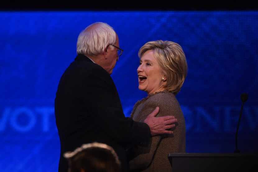  US Democratic presidential hopefuls Hillary Clinton (R) confers with fellow candidate...