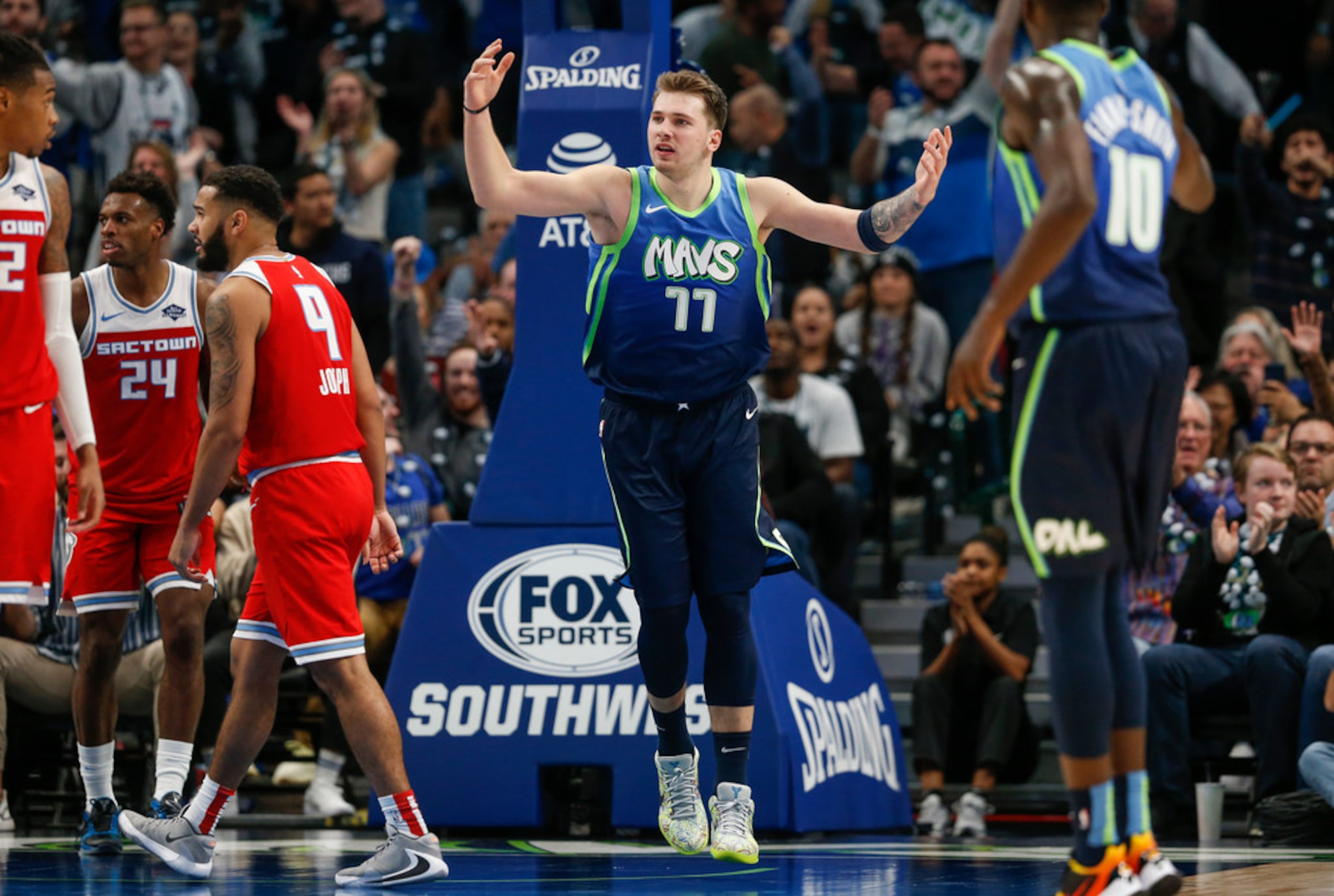 Dallas Mavericks forward Luka Doncic (77) celebrates scoring during the second half of a NBA...