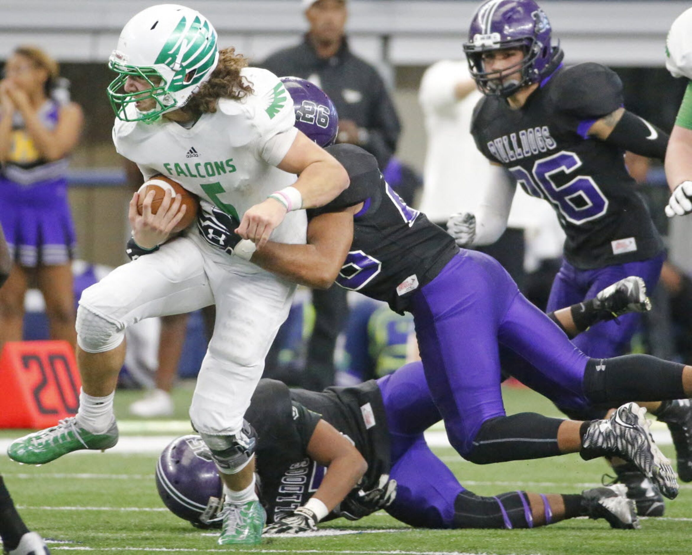 Lake Dallas quarterback Dagan Haehn (5) runs for yardage as Everman's Jaylon Sparks (26)...