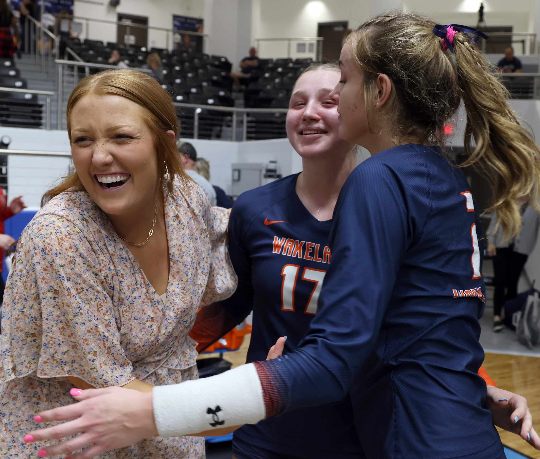 Frisco Wakeland assistant volleyball coach Ally Cobb, left, celebrates with players Keala...