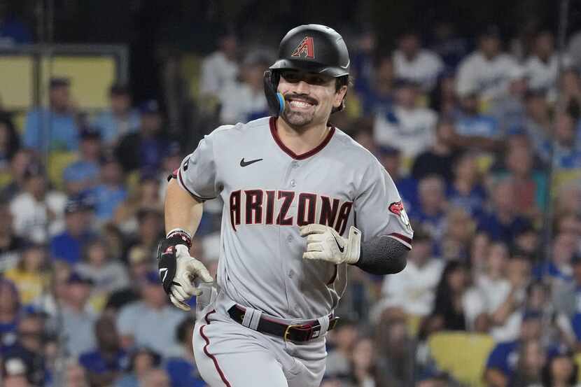 Arizona Diamondbacks' Corbin Carroll smiles as he rounds the bases after hitting a home run...