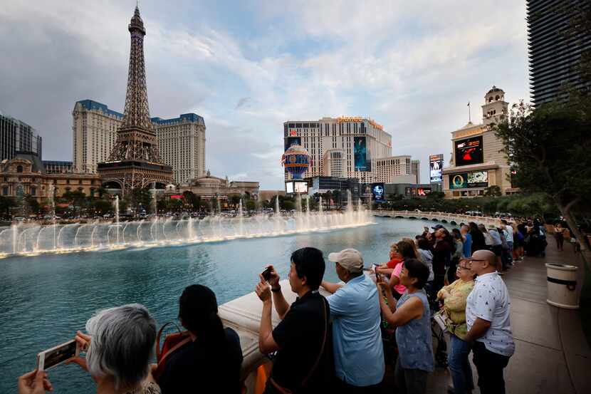 File image of tourists watching the dancing water feature at Bellagio Fountain along the Las...