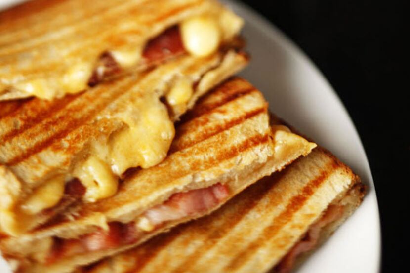 The Ultimate Grilled Cheese sandwich includes bacon, three cheeses and mustard-spiked...