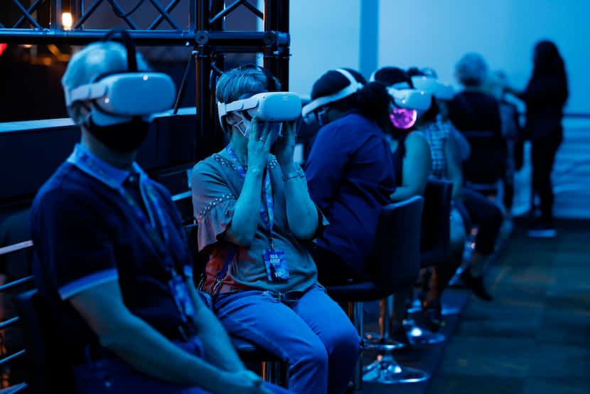 Visitors sit for a virtual reality experience at Van Gogh: The Immersive Experience at...