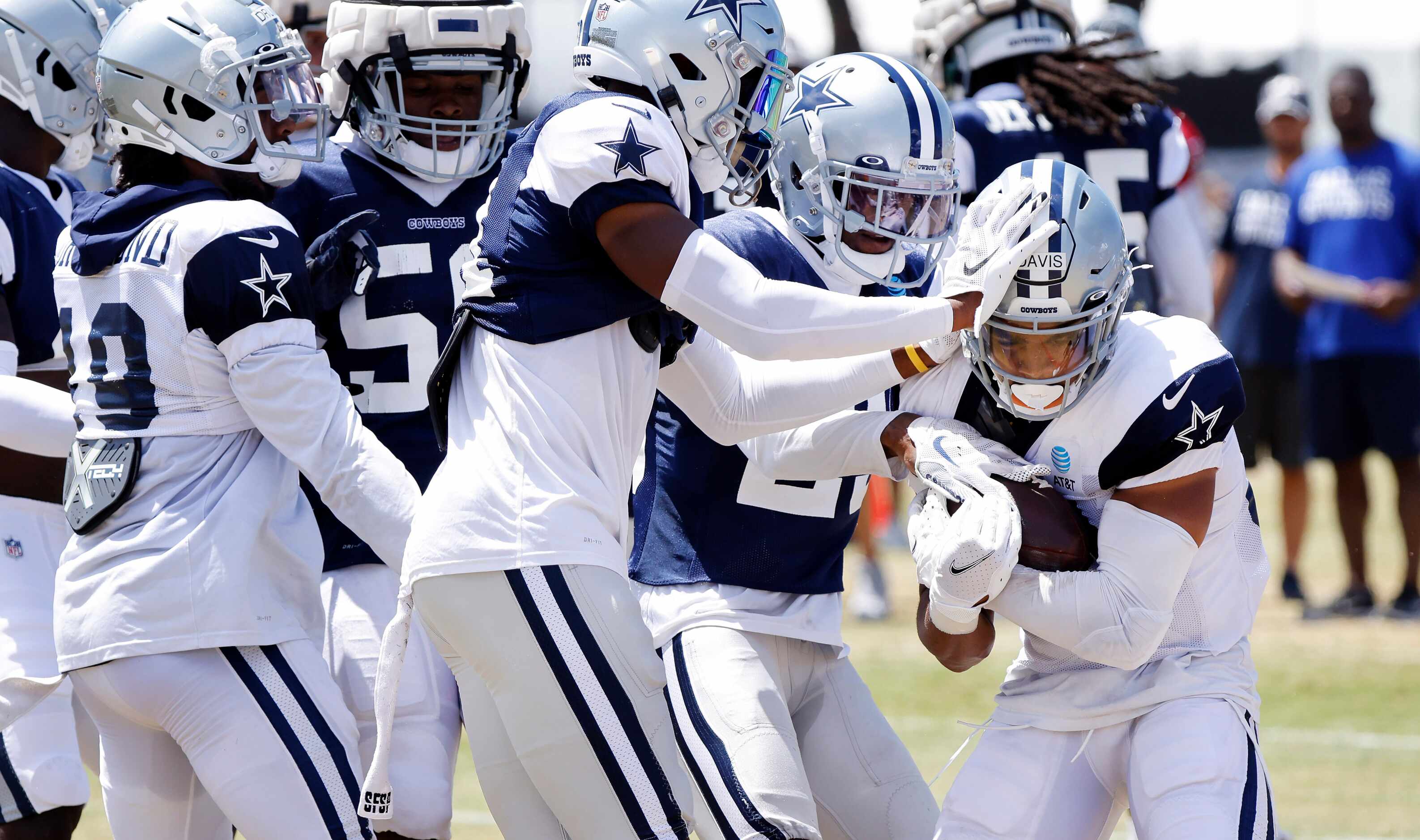 Dallas Cowboys running back Malik Davis (34) is tackled by the defense during a training...