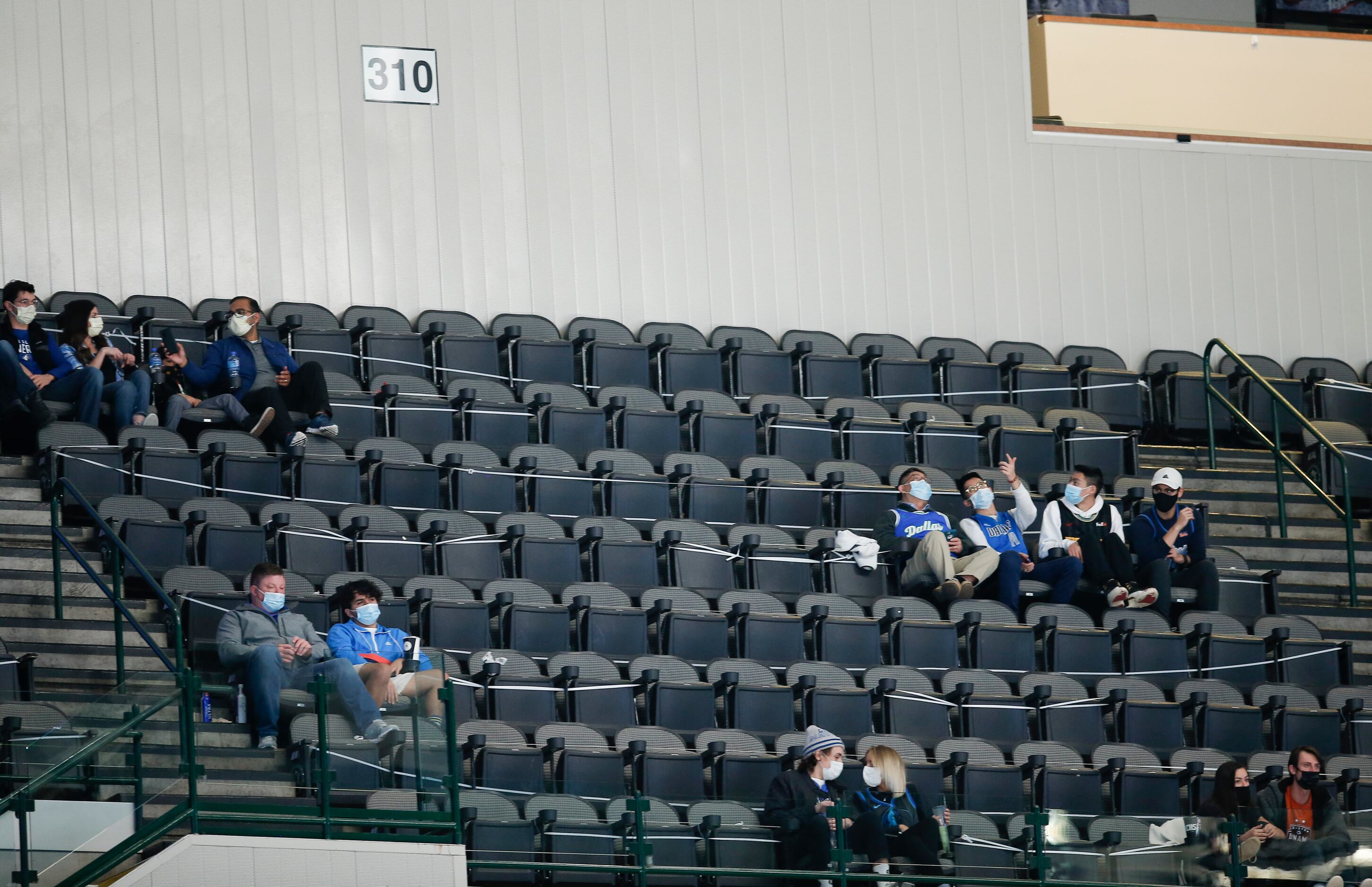 Fans sitting in the 310 section, consisting mostly of health care workers, attend the...