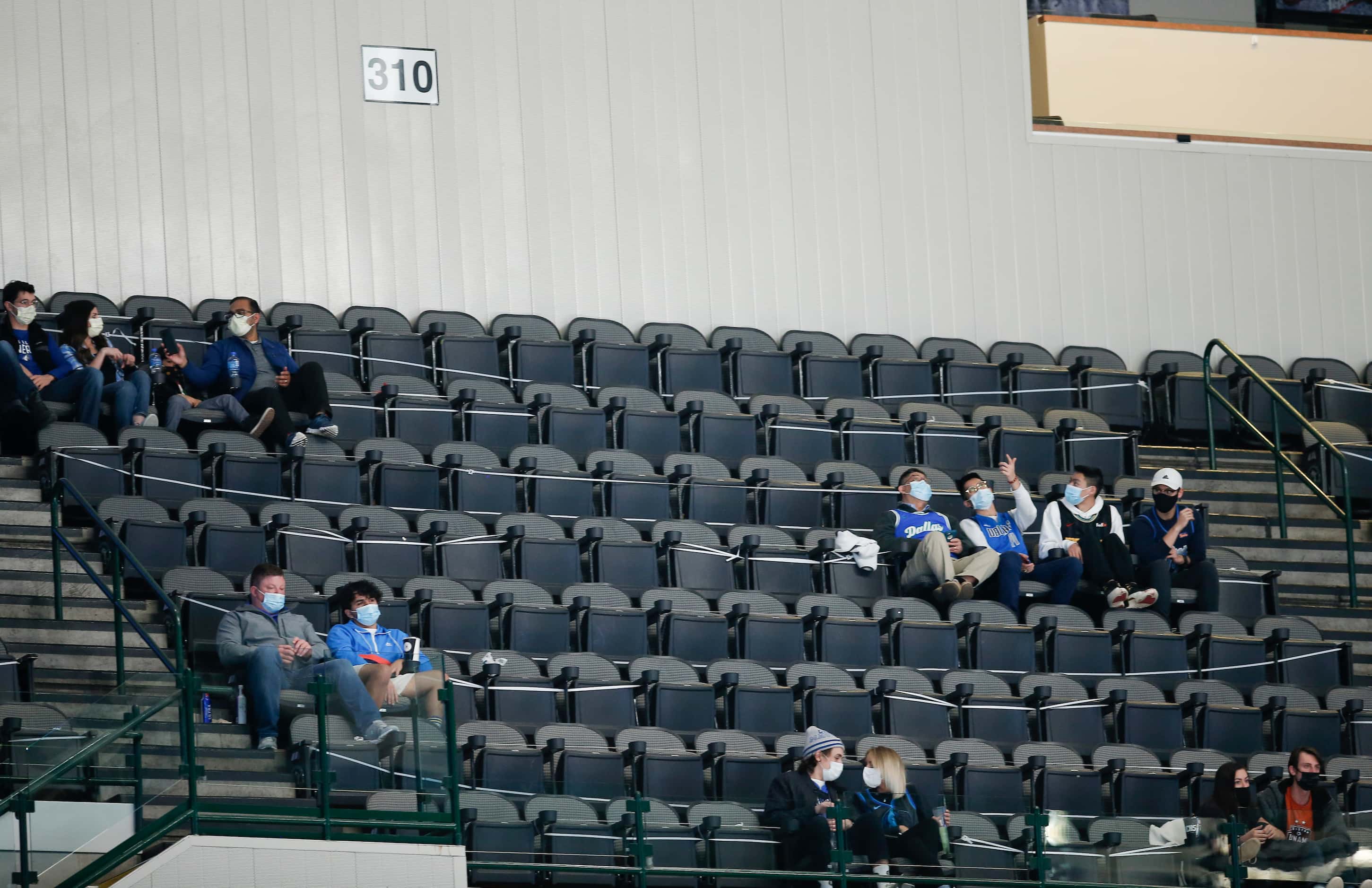 Fans sitting in the 310 section, consisting mostly of health care workers, attend the...