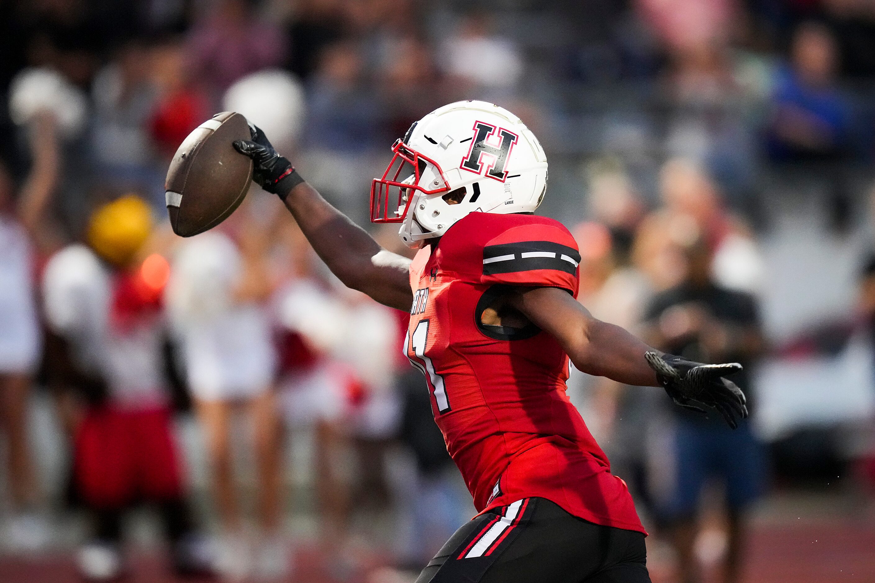 Rockwall-Heath linebacker Jayden Lexion (41) celebrates after scooping up a Euless Trinity...