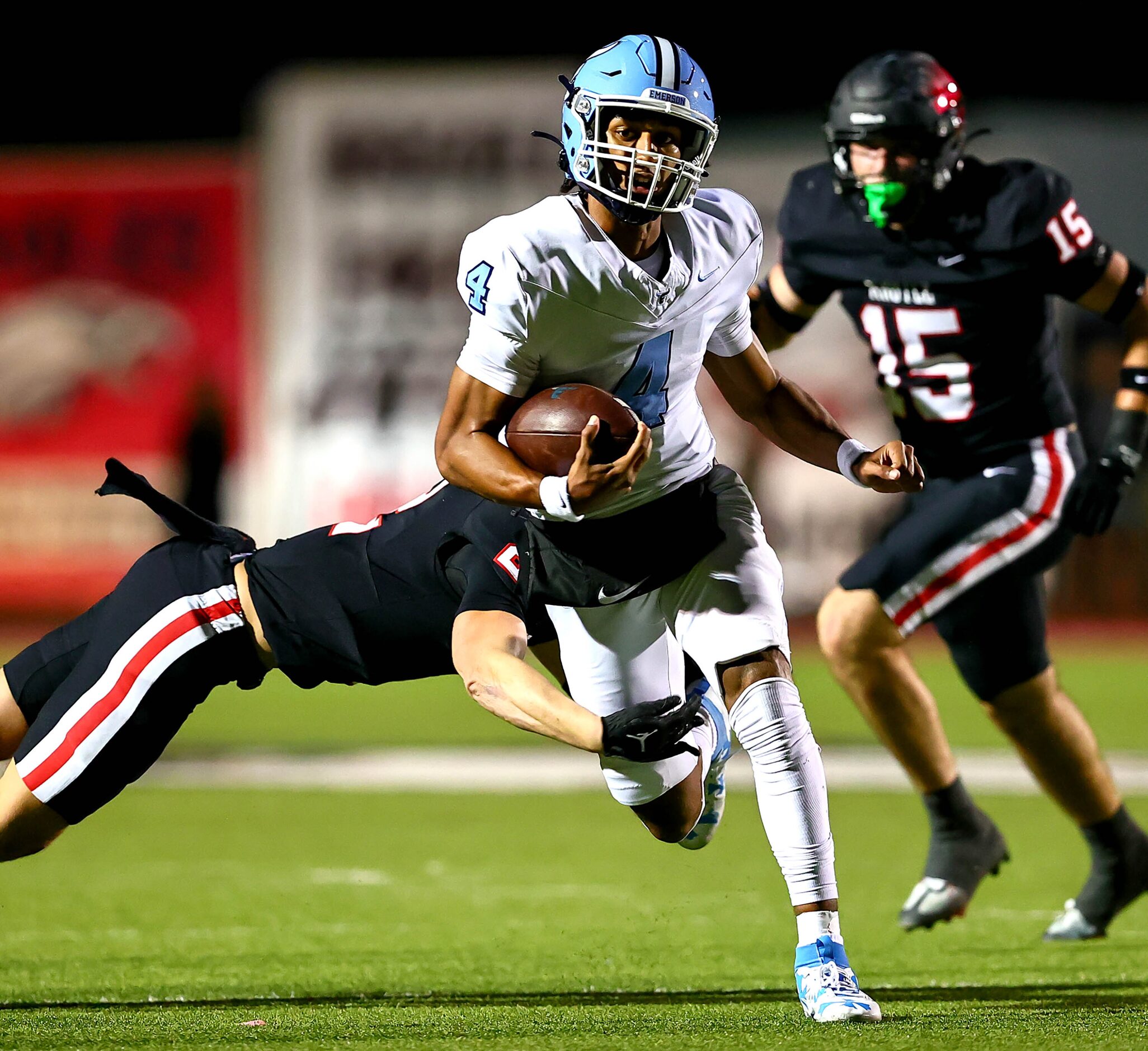 Frisco Emerson quarterback Michael Hawkins (4) tries to break a tackle against Argyle...