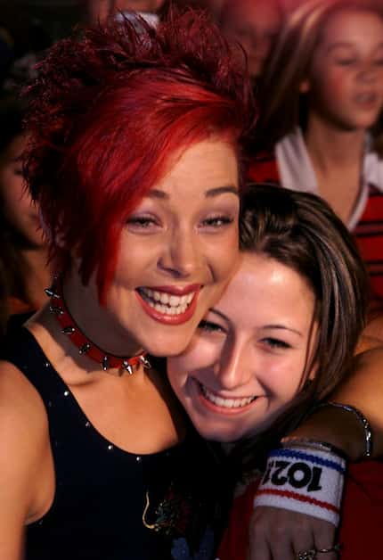 Nikki McKibbin, left, hugs her friend Deana Hale at Rack Daddy's in Arlington.