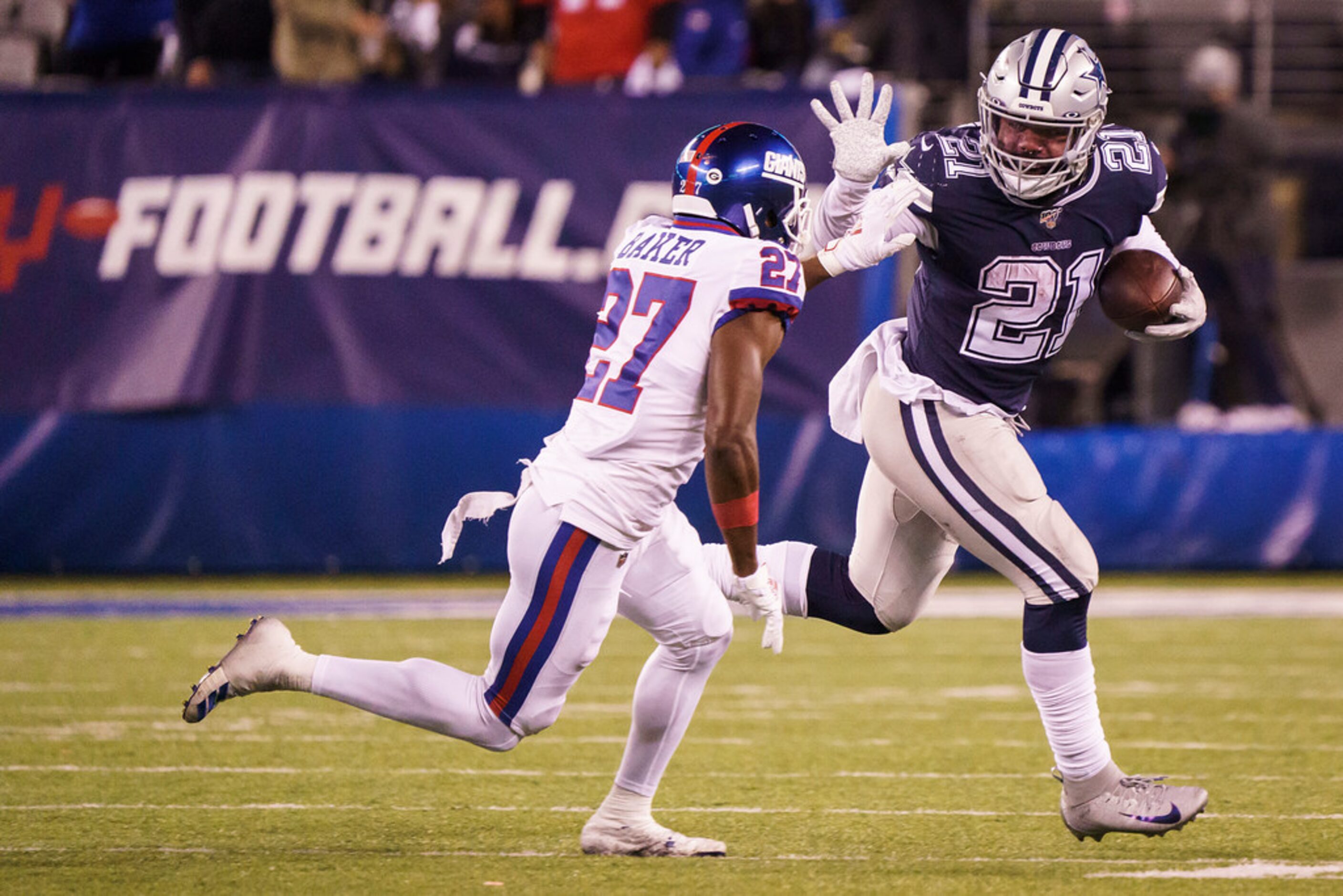 Dallas Cowboys running back Ezekiel Elliott (21) pushes off of New York Giants cornerback...