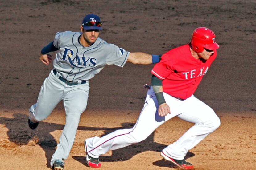 Texas Rangers right fielder Nelson Cruz walks back to the dugout after striking out against...