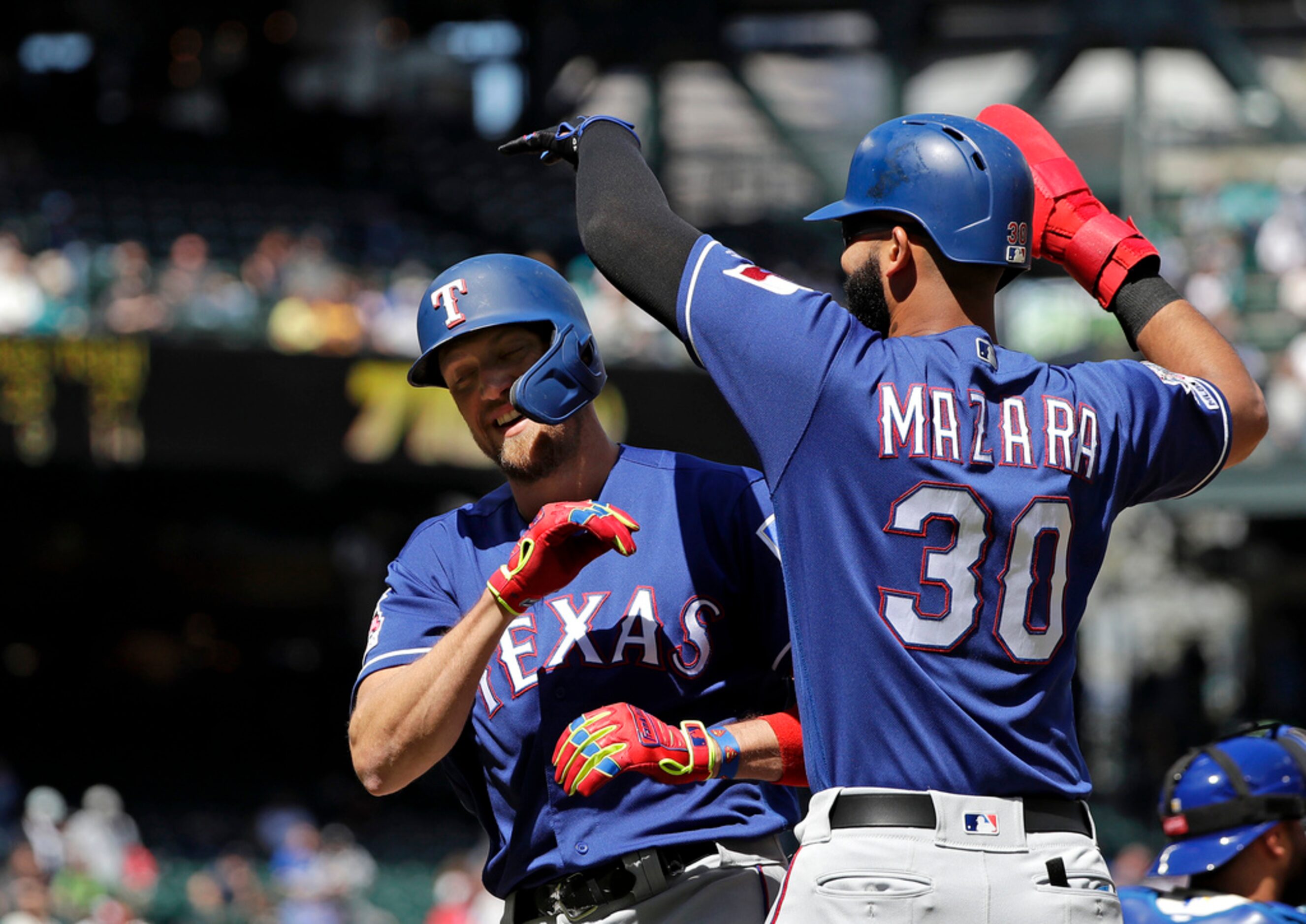 Texas Rangers' Hunter Pence, left, is greeted by Nomar Mazara after hitting a two-run home...