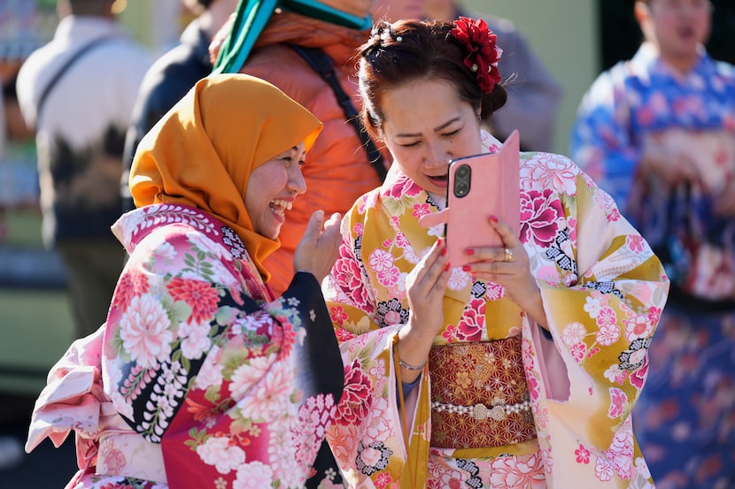 A woman from Nagoya, left, and her friend from Tokyo, both originally from Indonesia, react...