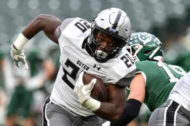 Guyer’s Ty Alridge (20) carries the ball while being chased down by the Arlington defense...