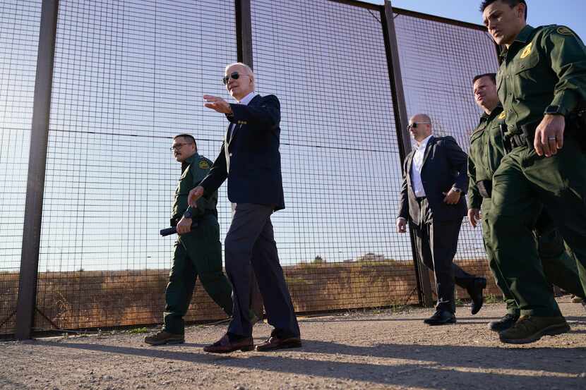 FILE - President Joe Biden walks along a stretch of the U.S.-Mexico border in El Paso Texas,...