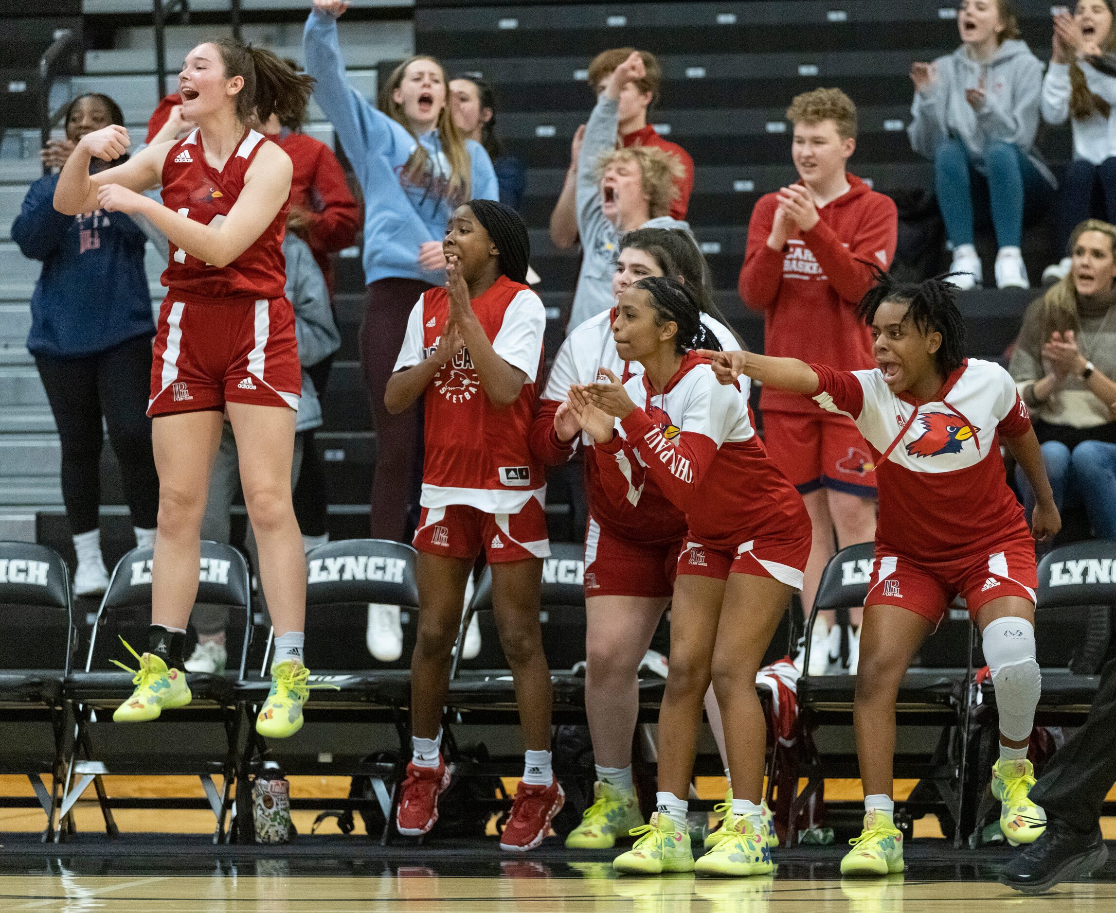 Players from John Paul II High School celebrate as they score in the fourth quarter during...