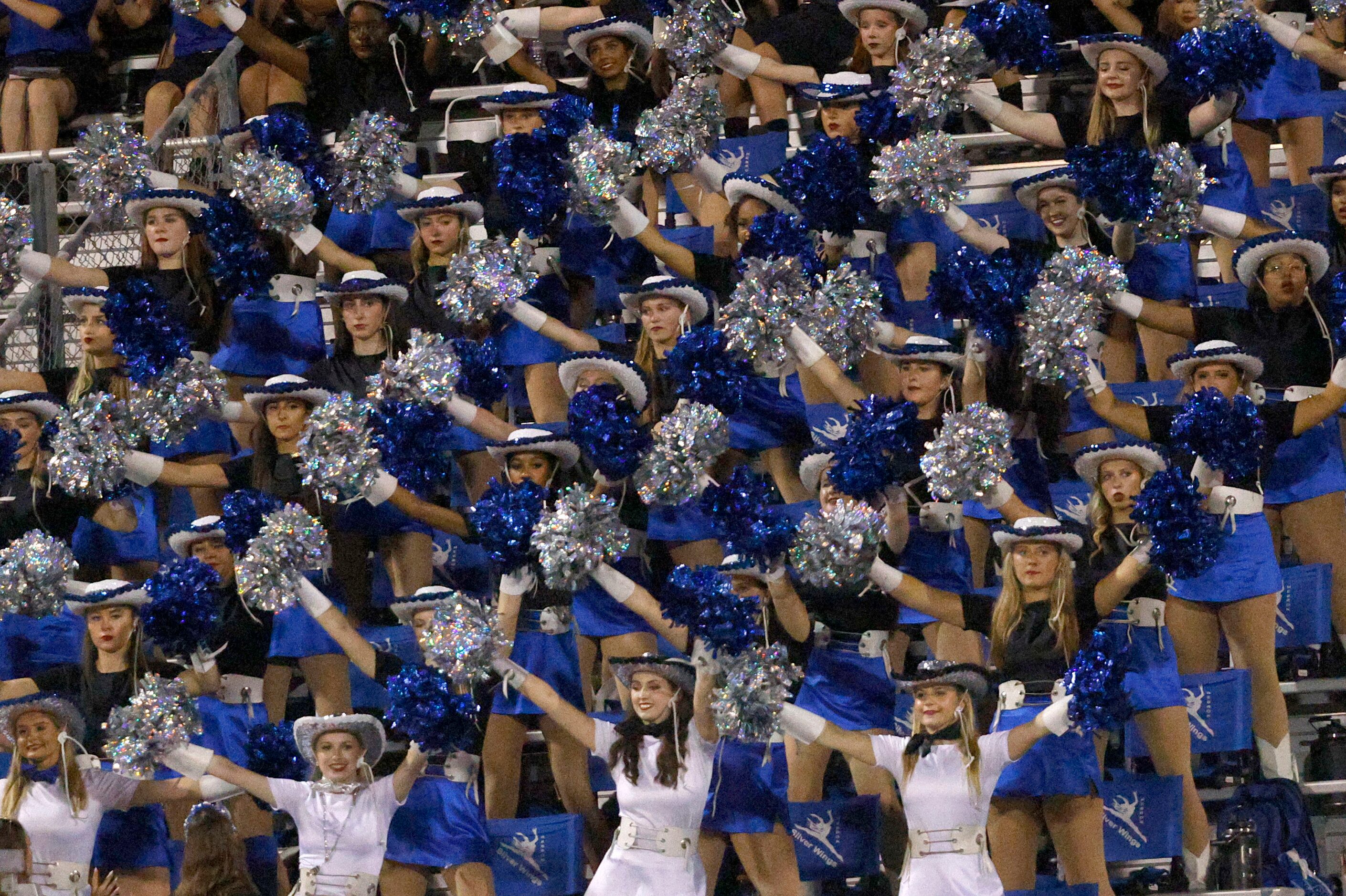 Hebron High School Silver Wings members perform before a high school football game against...