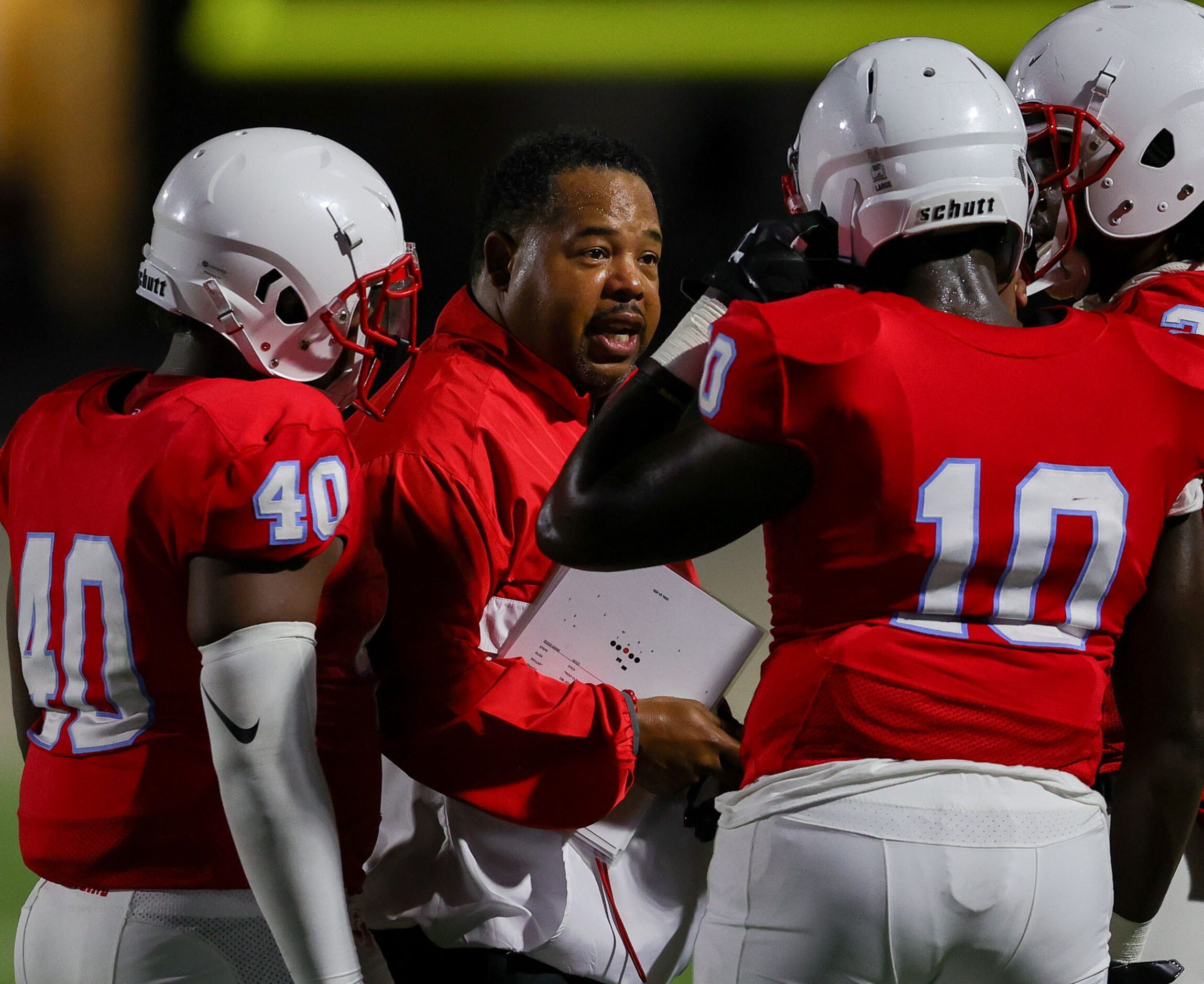 Skyline head coach Herman Johnson talks with his team during the game against South Grand...