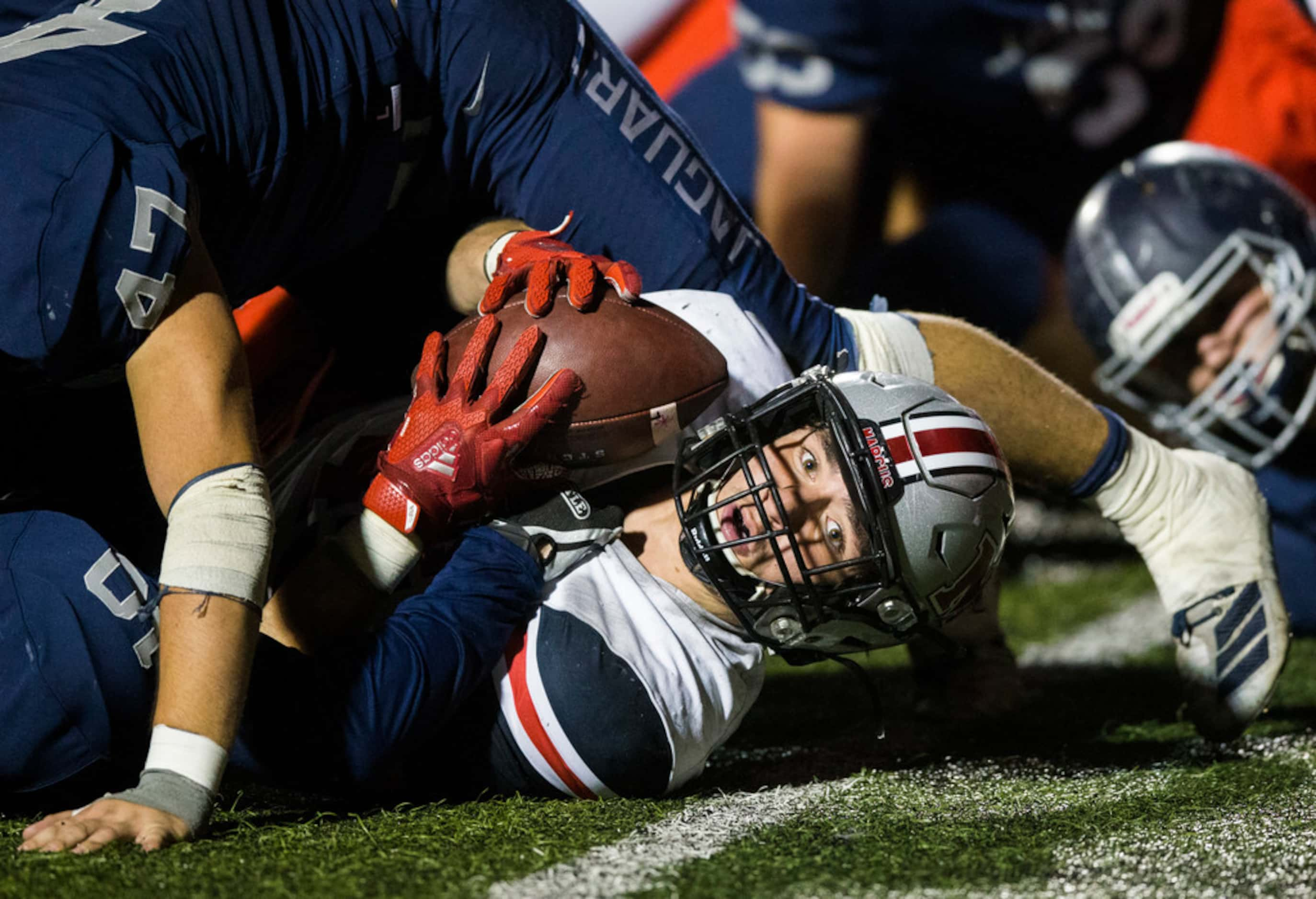 Flower Mound Marcus linebacker Tyler Gainey (45) falls across the goal line for the winning...