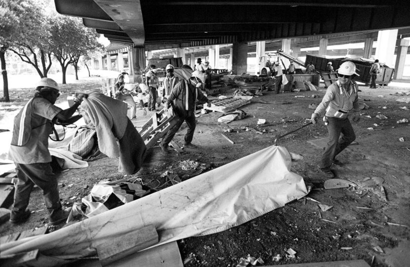  Street Dept. workers for the City of Dallas take apart the shanty town under the I-45...