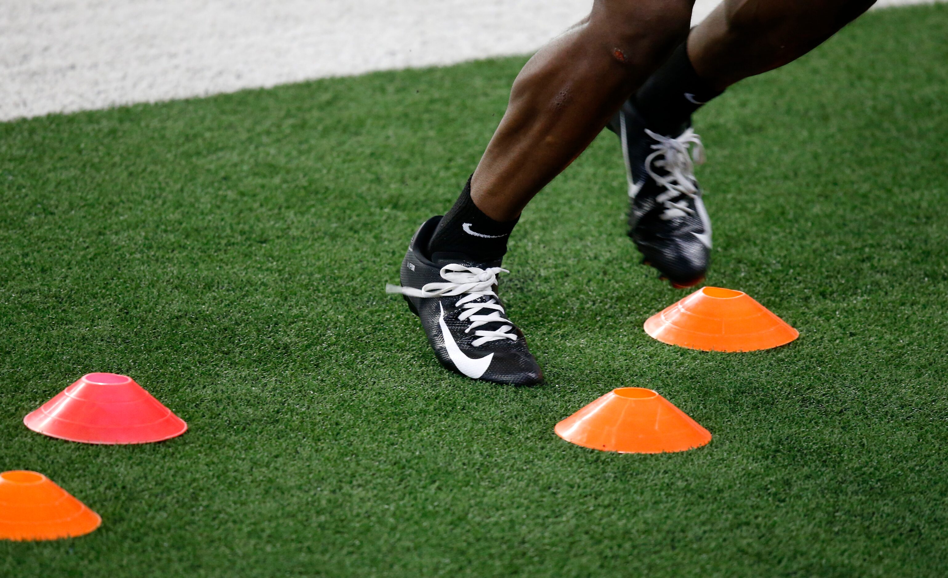 Dallas Cowboys receivers work on their footwork in practice during training camp at the...