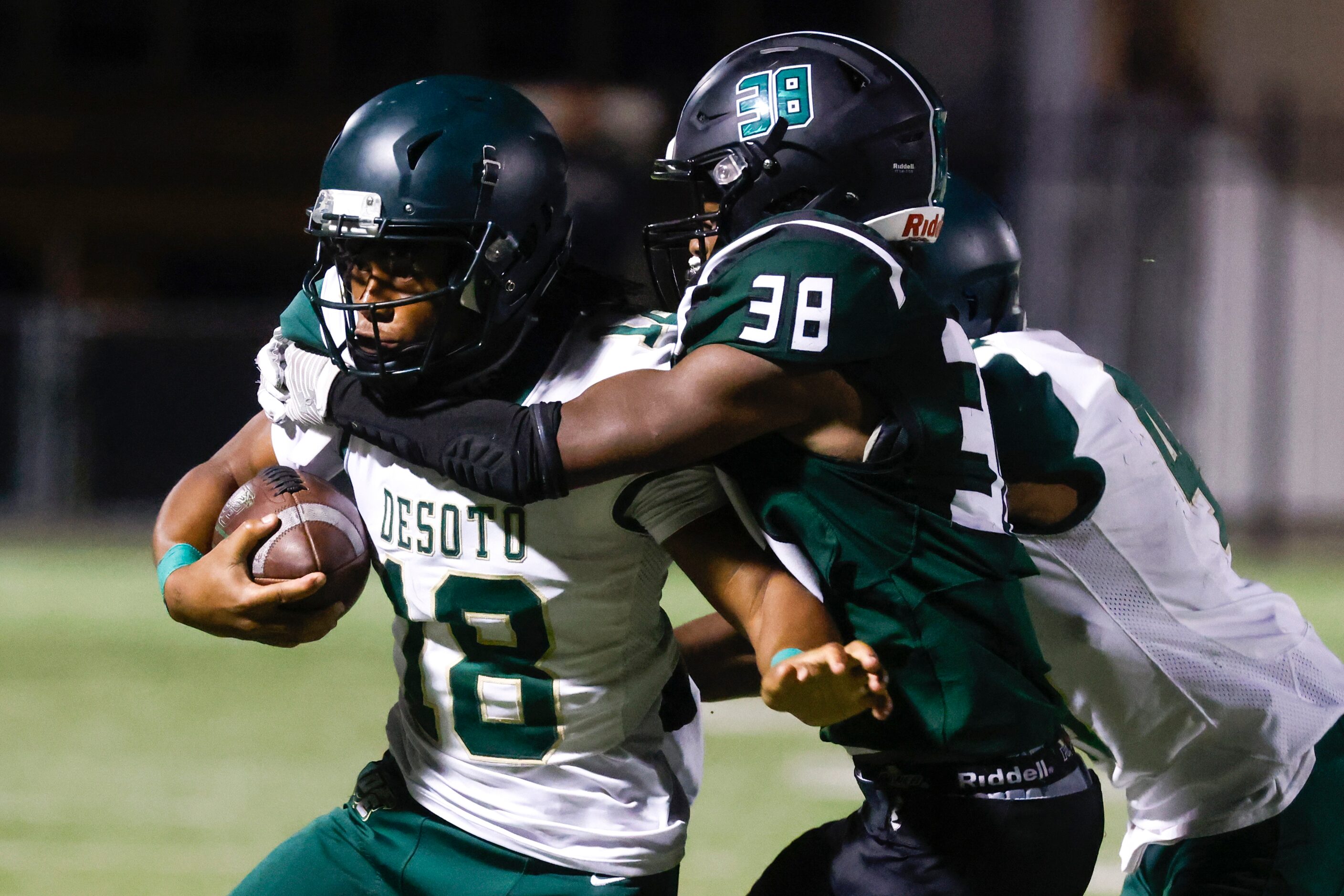 Lake Ridge High’s Kobe Ridgeway (38), right, tackles DeSoto High’s Armire Wiliams-Hall (18)...