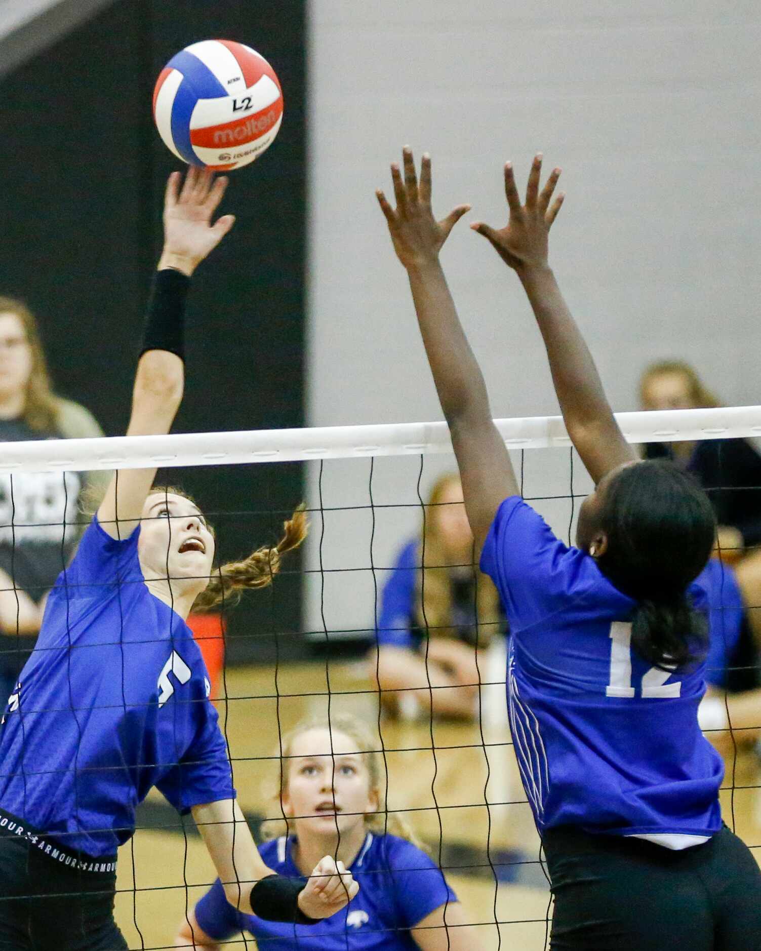 Trophy Club Byron Nelson middle blocker Nora Conway (6) hits the ball over Denton Guyer...