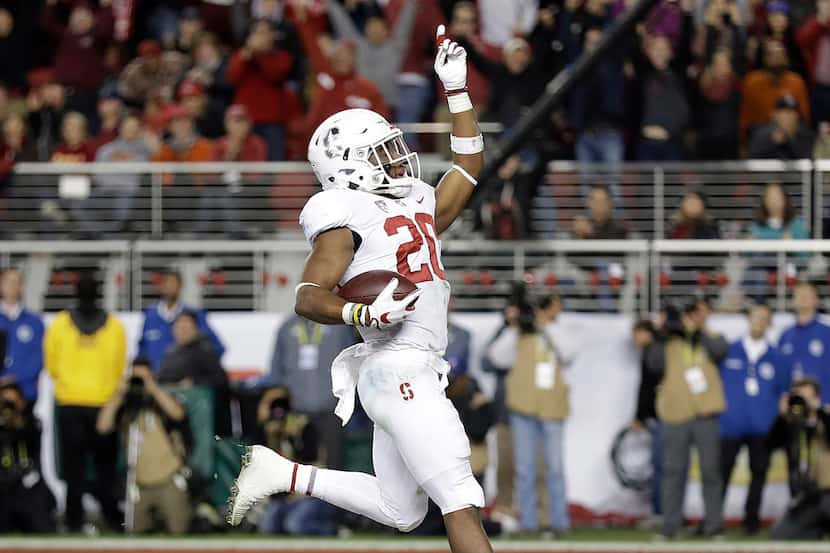 FILE - In this Dec. 1, 2017, file photo, Stanford running back Bryce Love (20) celebrates...