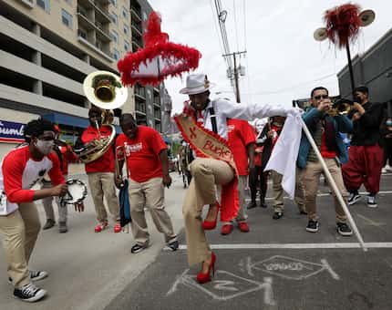 "¡Soltar!" grandmaster and choreographer Michelle Gibson steps lively in a procession to the...