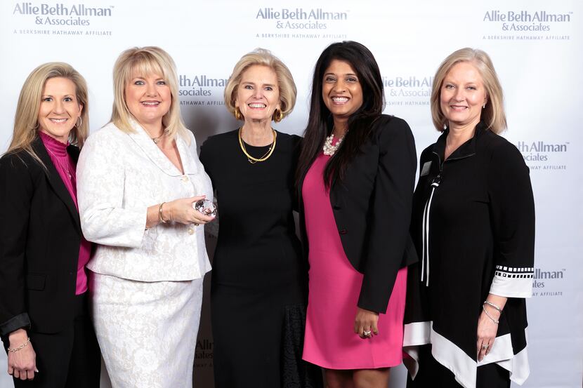 President/CEO Allie Beth Allman (center) congratulates the Dona Robinson Group for being...